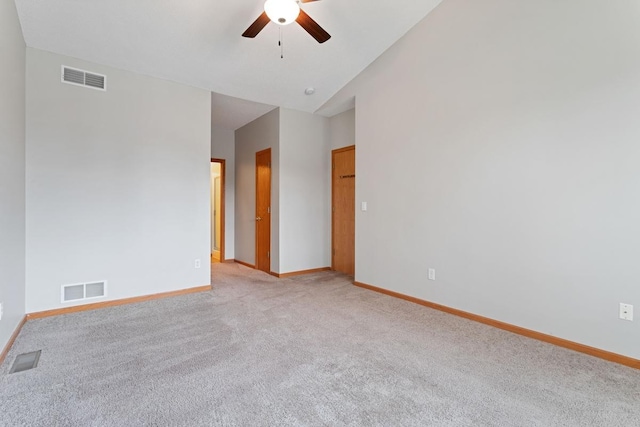 empty room with ceiling fan, light colored carpet, baseboards, and lofted ceiling