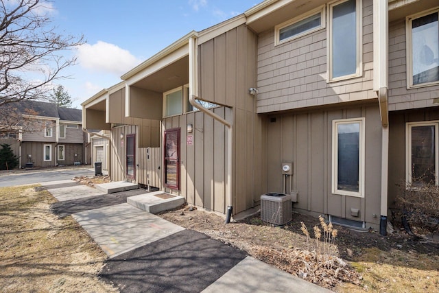 exterior space with central air condition unit and board and batten siding