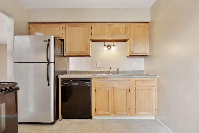 kitchen featuring light brown cabinetry, a sink, freestanding refrigerator, and black dishwasher
