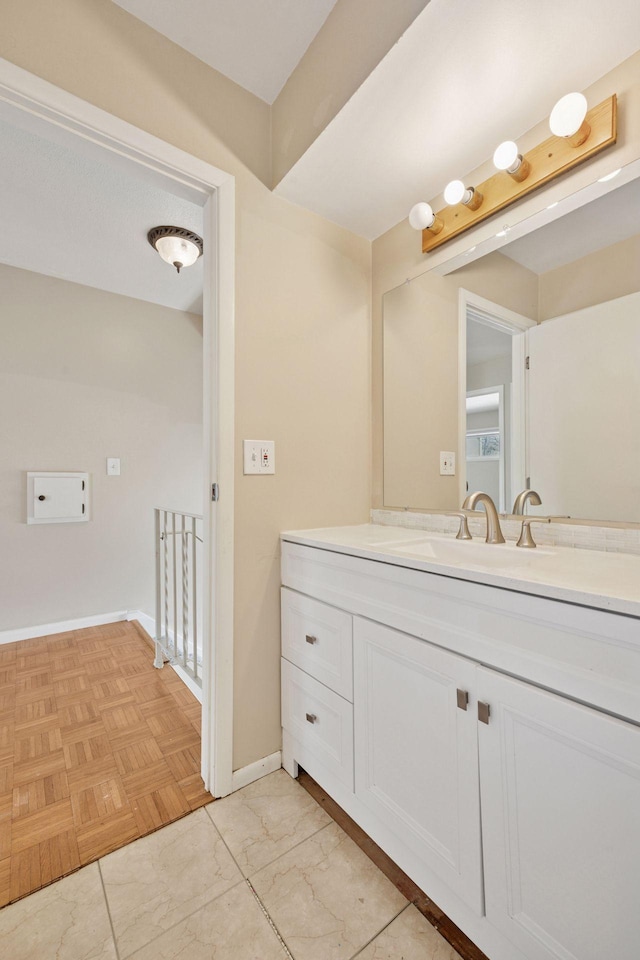bathroom with vanity and baseboards