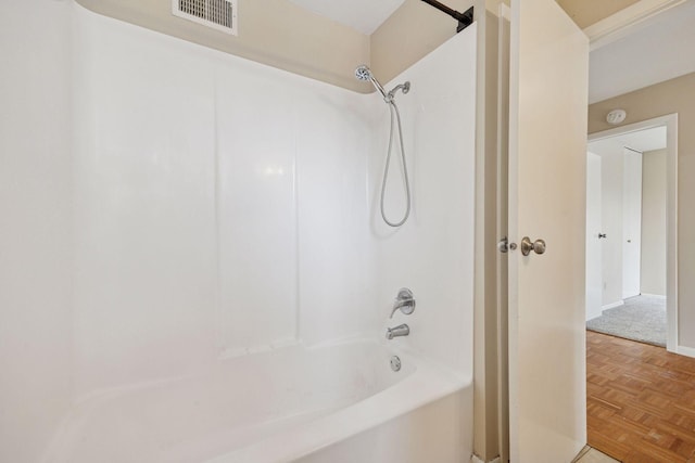 bathroom featuring baseboards, shower / tub combination, and visible vents