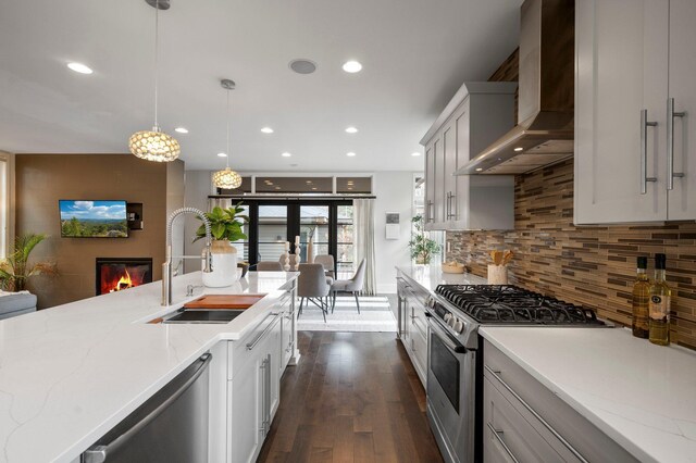 5231 Washburn Ave S, Minneapolis, MN 55410 - kitchen featuring stainless steel appliances, a sink, wall chimney exhaust hood, recessed lighting, and dark wood-style flooring