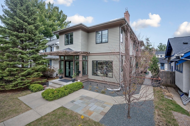 5231 Washburn Ave S, Minneapolis, MN 55410 - rear view of property with a chimney, fence, and a patio