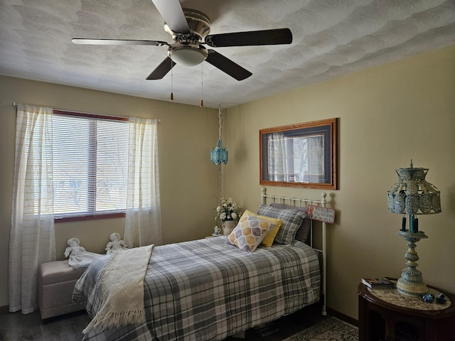 bedroom featuring a textured ceiling and ceiling fan