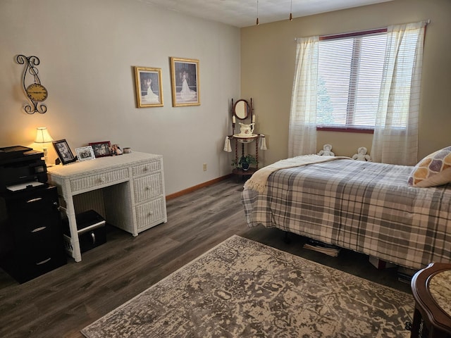 bedroom featuring dark wood-style flooring and baseboards