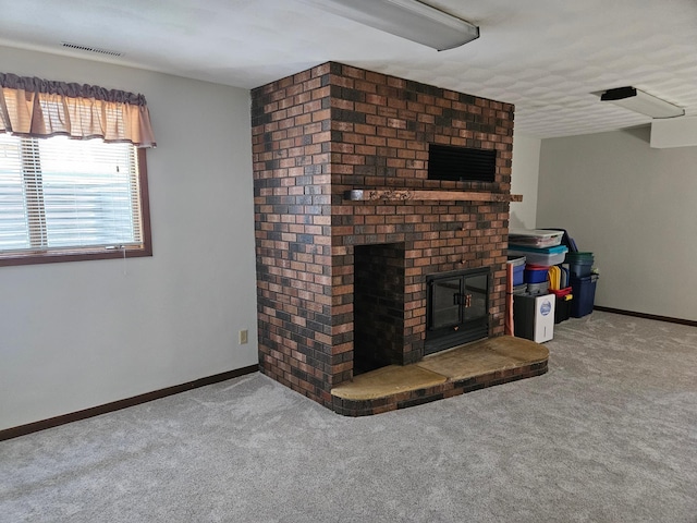 unfurnished living room with carpet floors, baseboards, and a fireplace