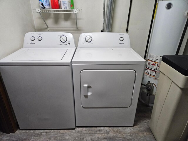 washroom featuring gas water heater, washer and dryer, and laundry area