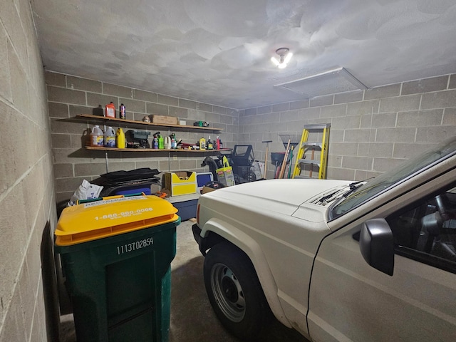 garage with concrete block wall