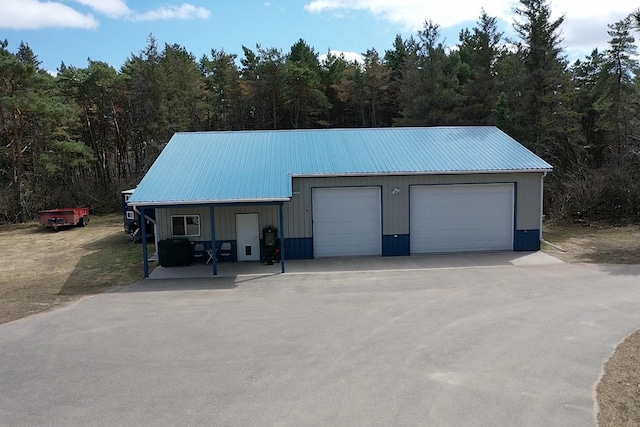 detached garage featuring a wooded view