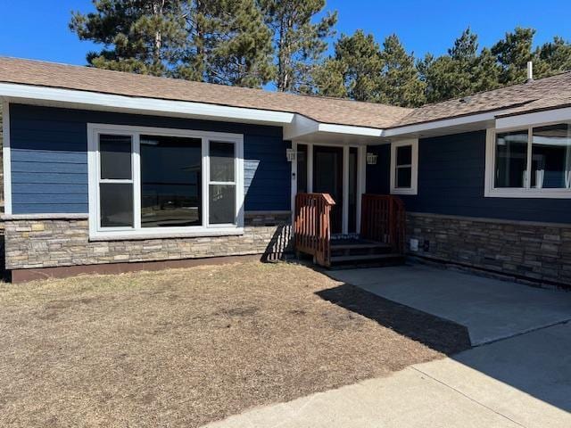 entrance to property featuring stone siding