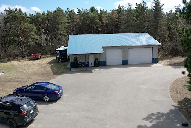 detached garage with a forest view