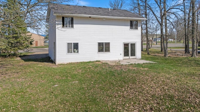 1607 7th Ave, Grand Rapids, MN 55744 - back of property featuring a yard and a patio
