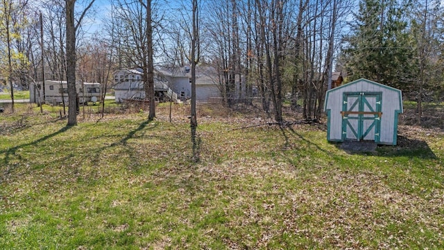 1607 7th Ave, Grand Rapids, MN 55744 - view of grassy yard featuring a storage unit and an outbuilding