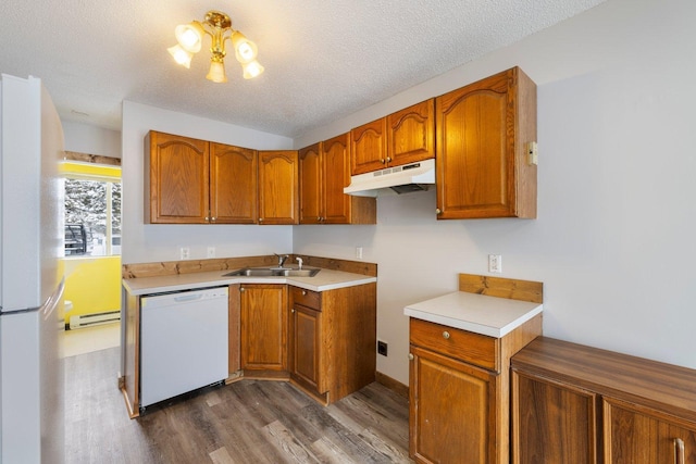 1607 7th Ave, Grand Rapids, MN 55744 - kitchen with white appliances, under cabinet range hood, a sink, dark wood-style floors, and a baseboard heating unit
