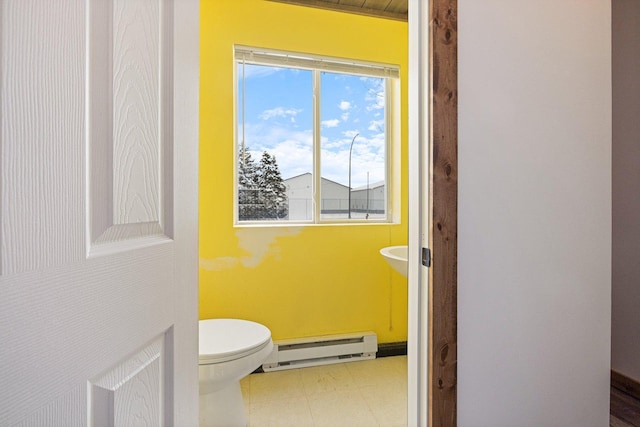 1607 7th Ave, Grand Rapids, MN 55744 - half bathroom with a baseboard radiator, healthy amount of natural light, and toilet