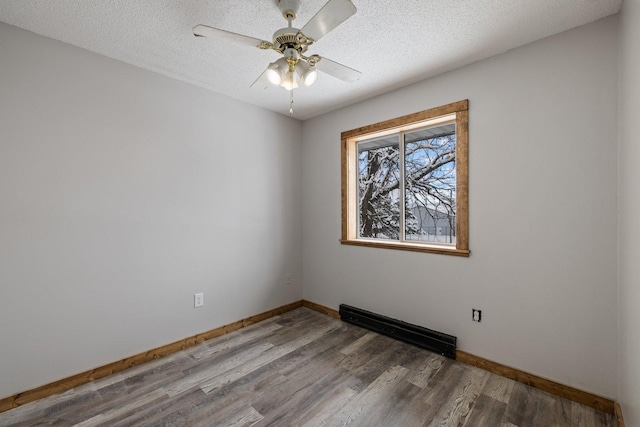 1607 7th Ave, Grand Rapids, MN 55744 - empty room with wood finished floors, ceiling fan, baseboards, and a textured ceiling