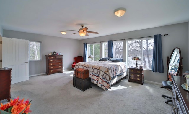 bedroom with ceiling fan, baseboards, and carpet
