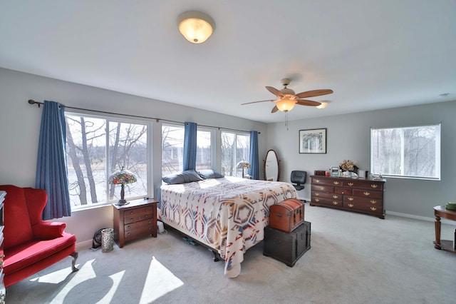 carpeted bedroom with baseboards and ceiling fan
