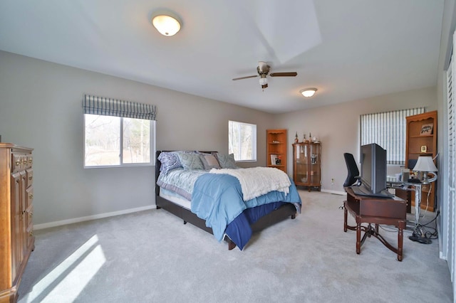carpeted bedroom with baseboards and a ceiling fan