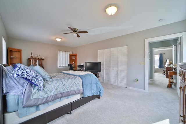carpeted bedroom with a ceiling fan, baseboards, and a closet