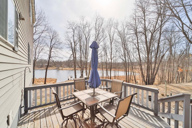 wooden deck featuring outdoor dining area and a water view