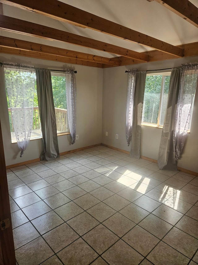 unfurnished room featuring lofted ceiling with beams, baseboards, and tile patterned flooring