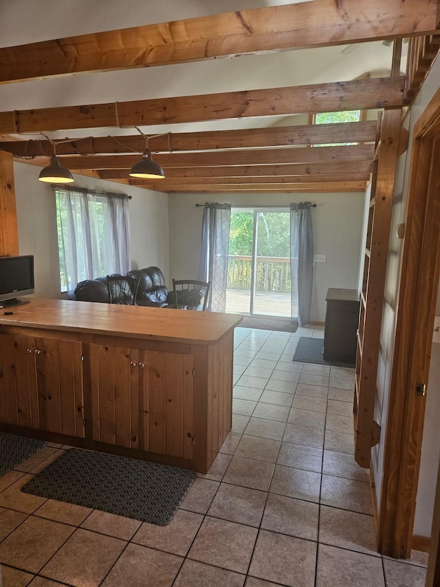 kitchen featuring beam ceiling and light tile patterned floors