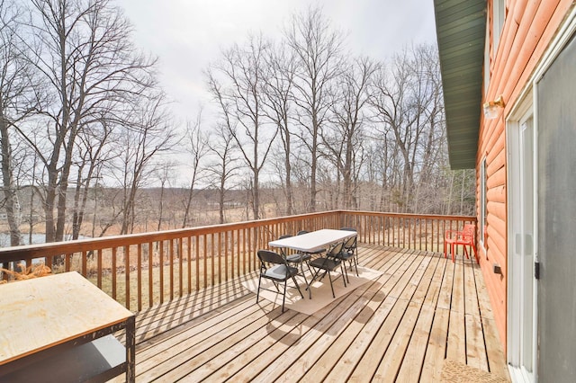 wooden deck featuring outdoor dining area