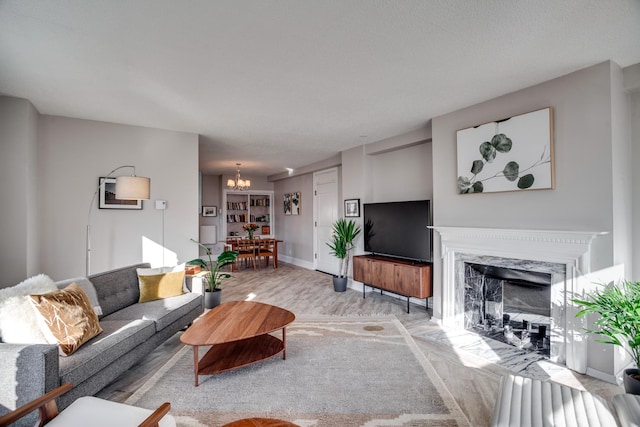 79 Western Ave N Unit 100, Saint Paul, MN 55102 - living area with wood finished floors, a chandelier, a high end fireplace, and baseboards