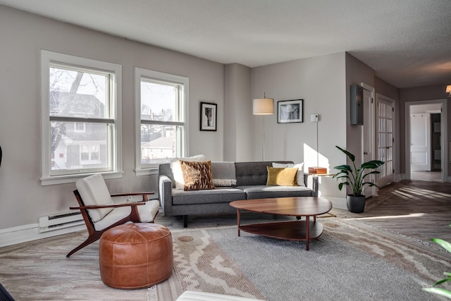 79 Western Ave N Unit 100, Saint Paul, MN 55102 - living area with baseboards, wood finished floors, and a baseboard heating unit