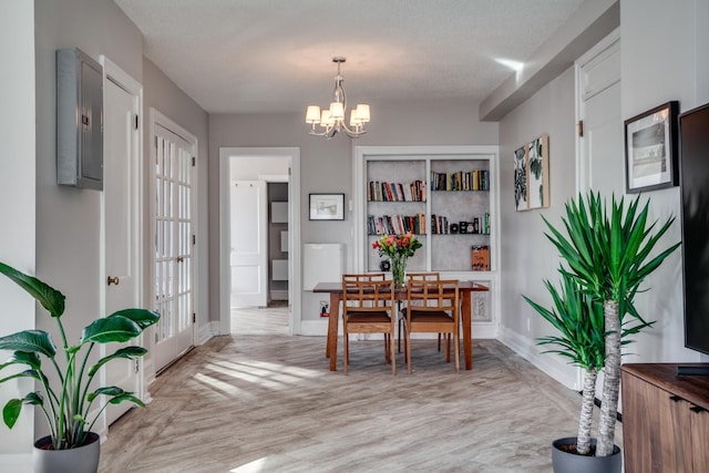 79 Western Ave N Unit 100, Saint Paul, MN 55102 - dining space with a chandelier, baseboards, and light wood-style floors
