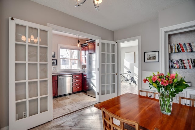 79 Western Ave N Unit 100, Saint Paul, MN 55102 - dining room featuring a chandelier, a textured ceiling, and french doors
