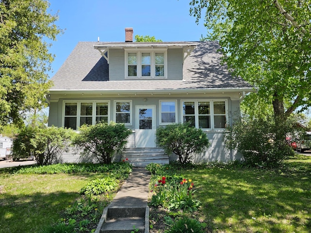 502 Park St S, Fairfax, MN 55332 - bungalow with a front yard, a chimney, entry steps, and a shingled roof