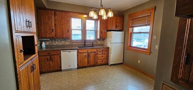 502 Park St S, Fairfax, MN 55332 - kitchen featuring white appliances, a sink, decorative backsplash, and brown cabinets
