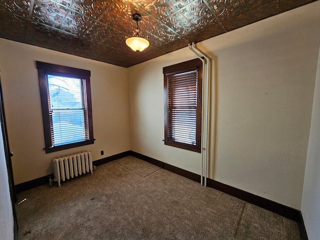 502 Park St S, Fairfax, MN 55332 - carpeted empty room with radiator heating unit, an ornate ceiling, and baseboards