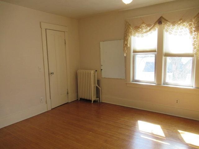 502 Park St S, Fairfax, MN 55332 - spare room with radiator heating unit, wood finished floors, and baseboards