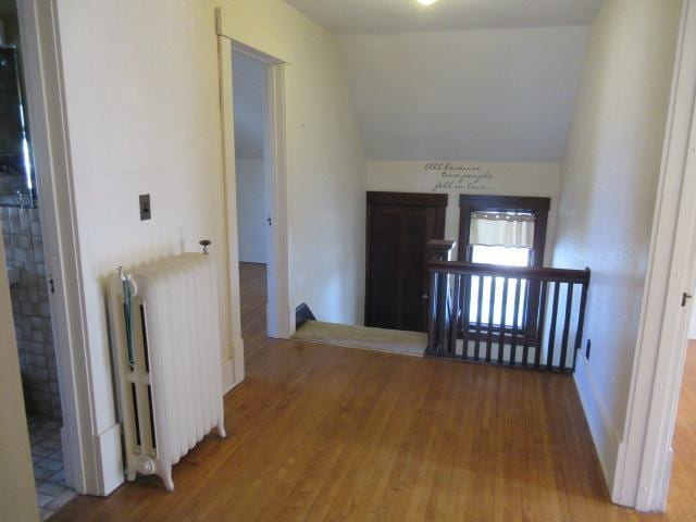 502 Park St S, Fairfax, MN 55332 - corridor with radiator, an upstairs landing, vaulted ceiling, and wood finished floors