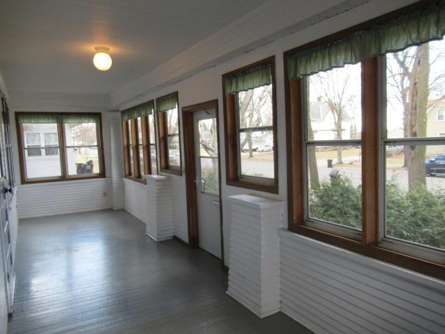 502 Park St S, Fairfax, MN 55332 - unfurnished sunroom with healthy amount of natural light, wood finished floors, and crown molding