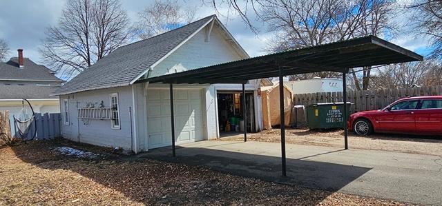 502 Park St S, Fairfax, MN 55332 - view of side of property featuring a carport, fence, and a garage
