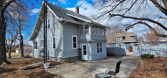 502 Park St S, Fairfax, MN 55332 - rear view of property featuring fence, a chimney, and a patio