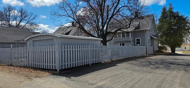 502 Park St S, Fairfax, MN 55332 - view of property exterior with a fenced front yard, driveway, and a garage