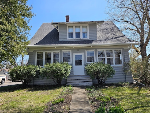 502 Park St S, Fairfax, MN 55332 - bungalow with entry steps, a chimney, a front yard, and roof with shingles