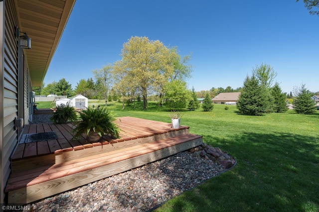 2615 Freeway Dr, Bloomer, WI 54724 - view of green lawn featuring a storage shed, a wooden deck, and an outdoor structure