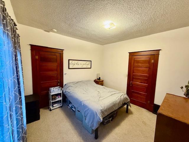 carpeted bedroom with a textured ceiling