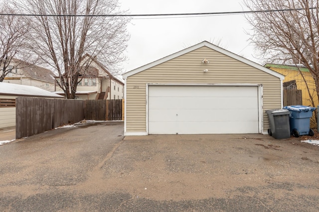 detached garage featuring fence