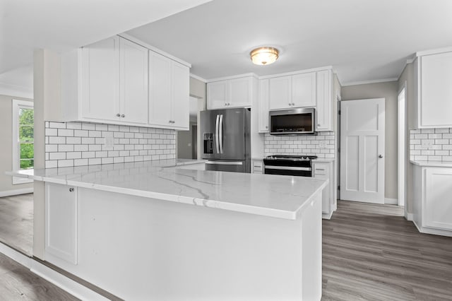 3401 Meadow Ln, Minnetonka, MN 55345 - kitchen with stainless steel appliances, a peninsula, white cabinets, wood finished floors, and crown molding