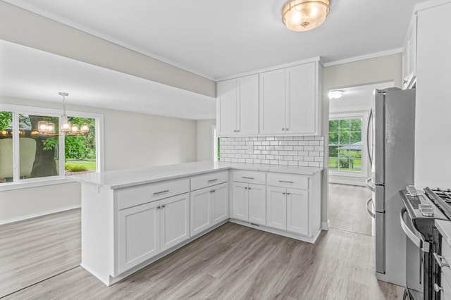 3401 Meadow Ln, Minnetonka, MN 55345 - kitchen with stainless steel appliances, a peninsula, light wood-style floors, and white cabinets