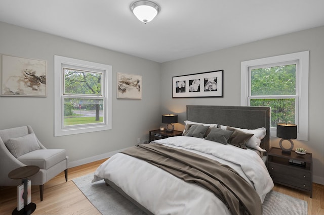 3401 Meadow Ln, Minnetonka, MN 55345 - bedroom with multiple windows, light wood-type flooring, and baseboards