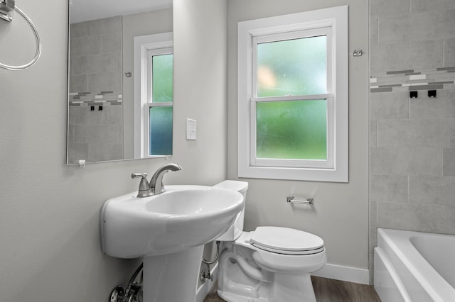 3401 Meadow Ln, Minnetonka, MN 55345 - bathroom with plenty of natural light, toilet, wood finished floors, and baseboards