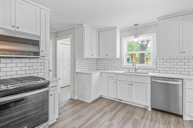 3401 Meadow Ln, Minnetonka, MN 55345 - kitchen with stainless steel appliances, a sink, decorative backsplash, light countertops, and crown molding
